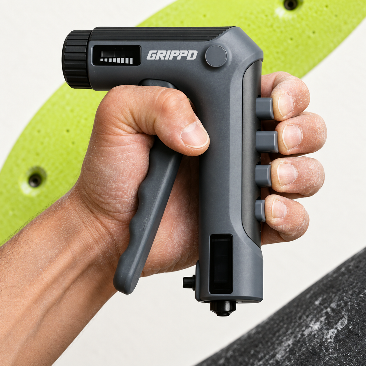 GRIPPD Send Pro adjustable finger strength trainer held in one hand with four finger buttons